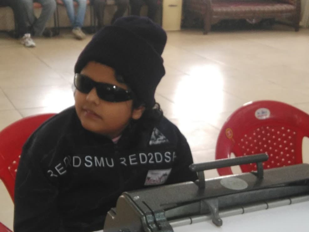 A student at a braille writer in class